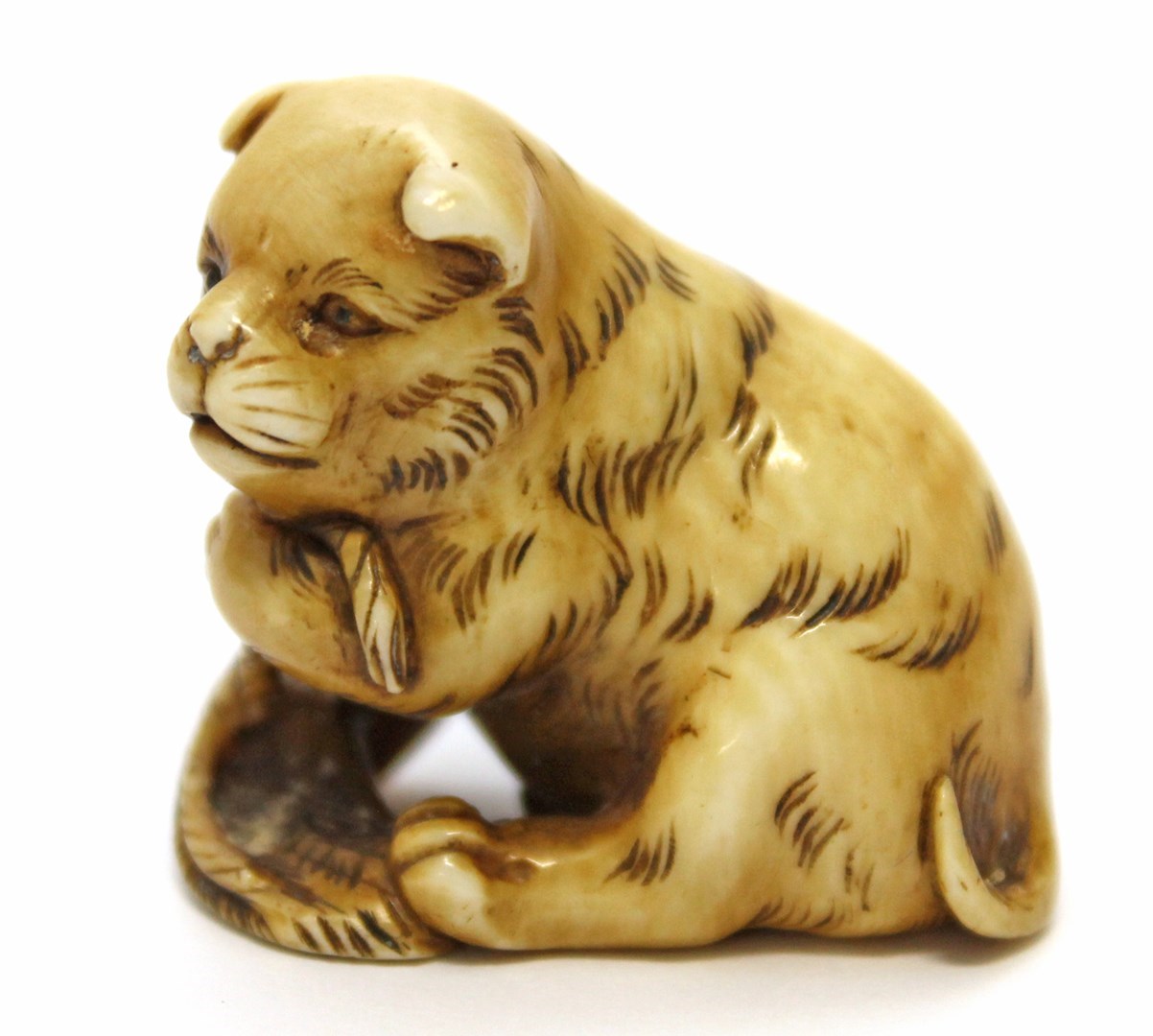 Appraisal: An ivory netsuke of a puppy Meiji period carved seated