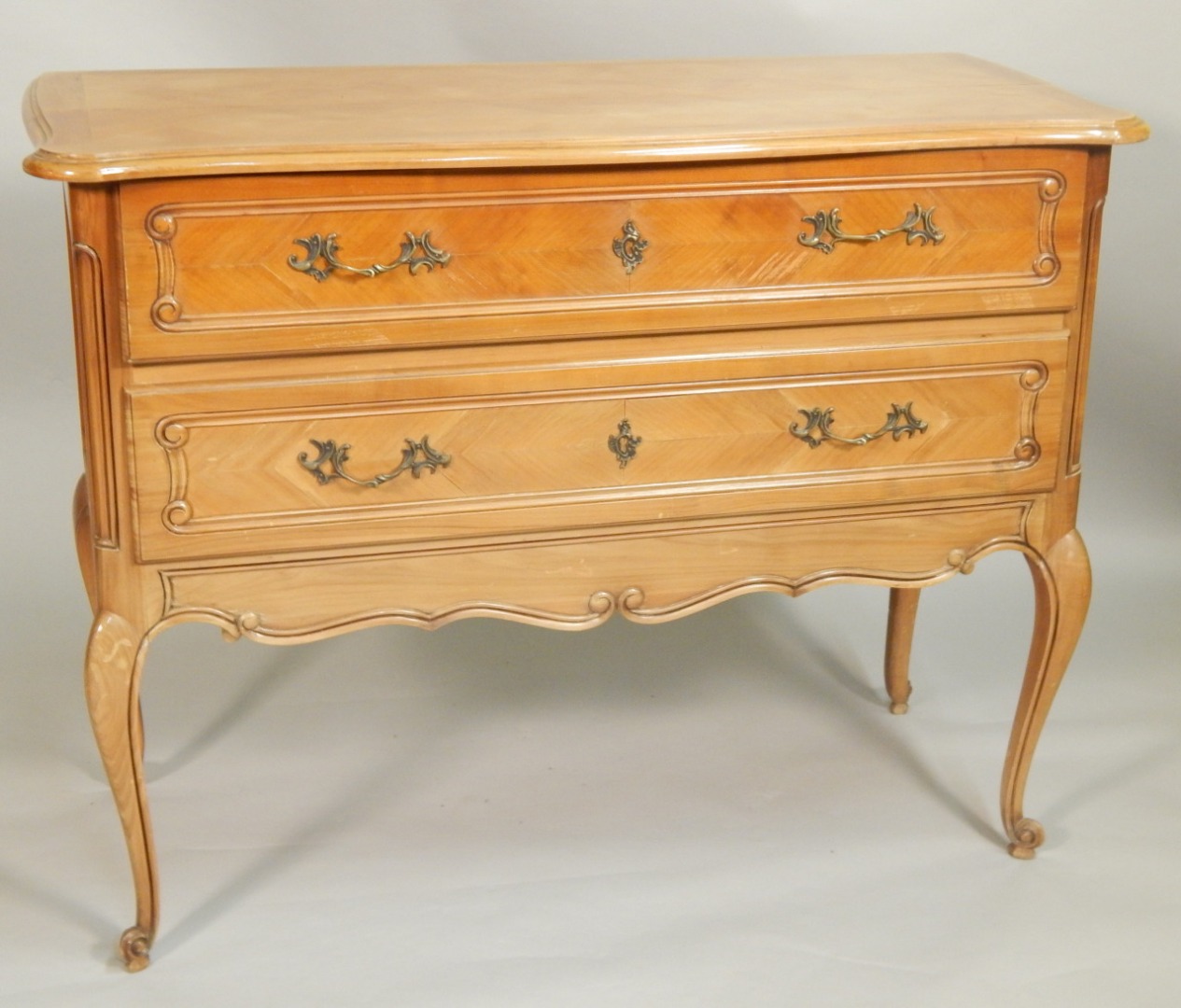 Appraisal: A reproduction French cherrywood desk the serpentine fronted hinged top