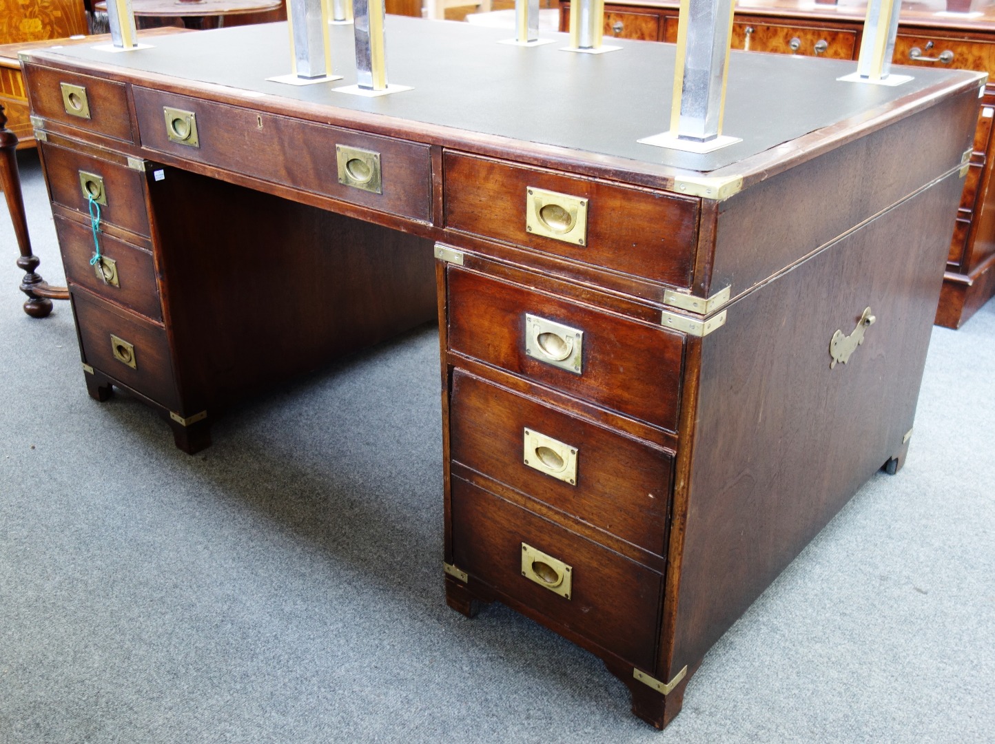 Appraisal: A brass bound mahogany campaign style pedestal desk with nine