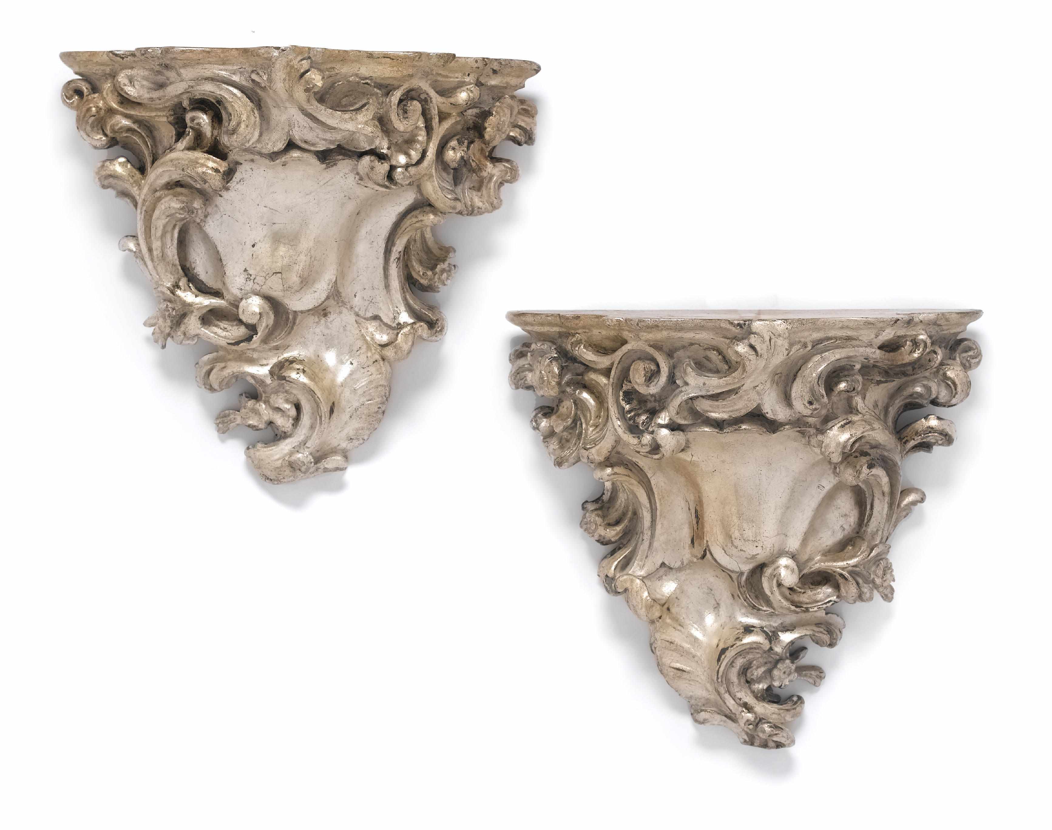 Appraisal: A pair of Italian Rococo style silvered wood wall brackets