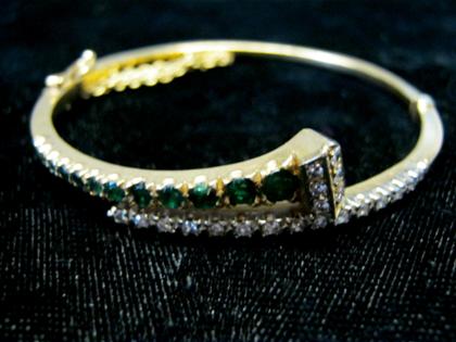 Appraisal: karat yellow gold diamond and emerald bangleTwelve round cut emeralds