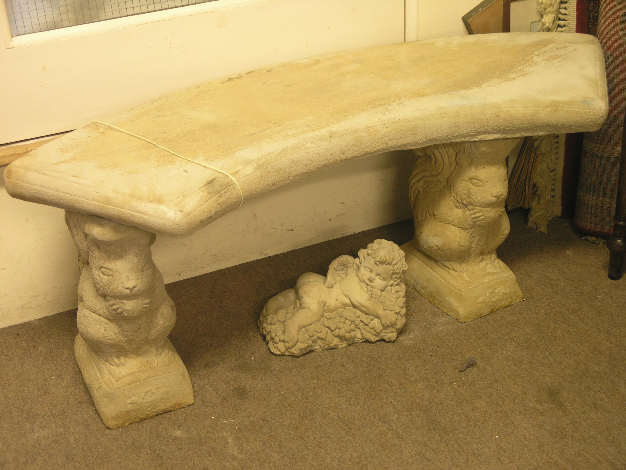 Appraisal: A moulded twin-seat garden bench on squirrel supports and a