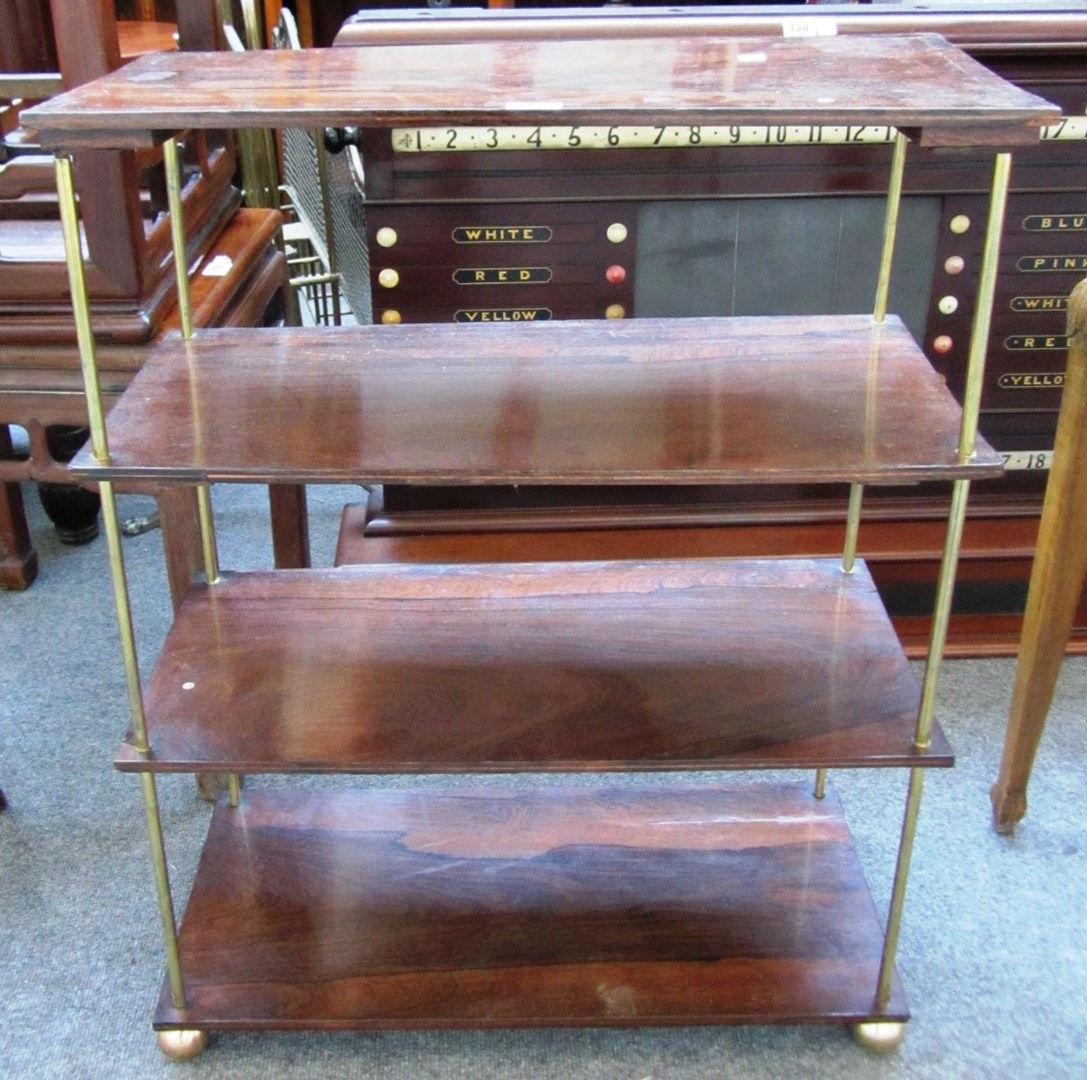 Appraisal: A rosewood floor standing open four tier etagere on turned