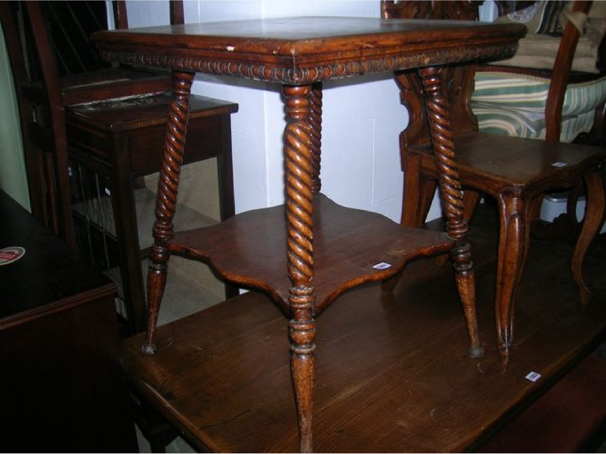 Appraisal: A Victorian oak two tier occasional table the square cut