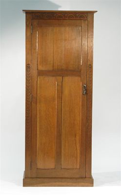 Appraisal: An oak hall cupboard possibly Wylie Lochhead with simple carved