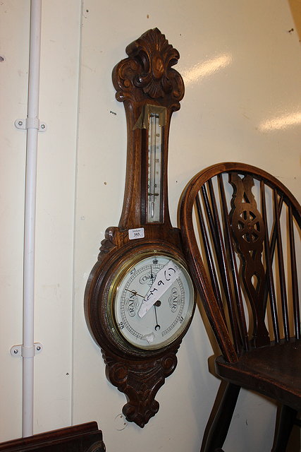 Appraisal: AN EARLY TH CENTURY CARVED OAK WHEEL BAROMETER cm in