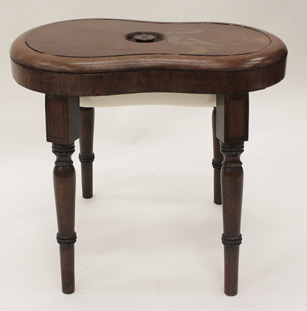 Appraisal: A GEORGE III MAHOGANY BIDET with porcelain liner on turned