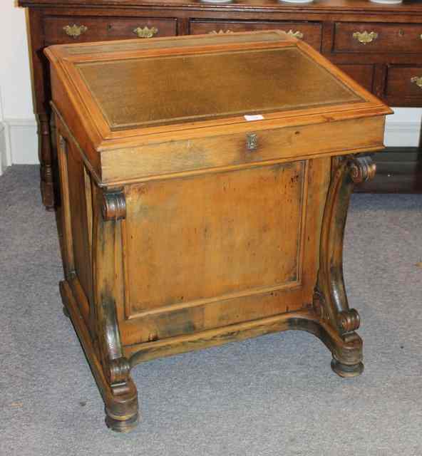 Appraisal: A VICTORIAN PINE DAVENPORT with rising lid with a bank