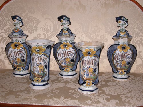 Appraisal: Title -piece Delft Ceramic Garniture Set comprising urns with covers