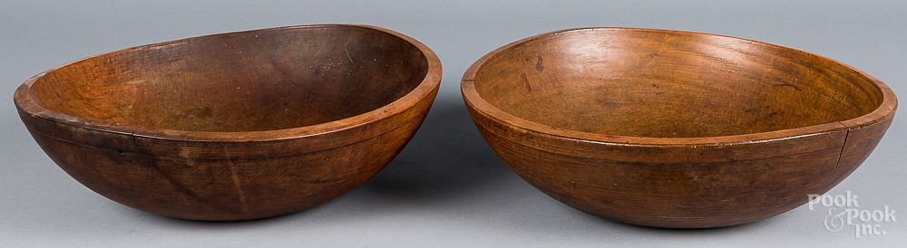 Appraisal: Two large turned wooden bowls th c Two large turned