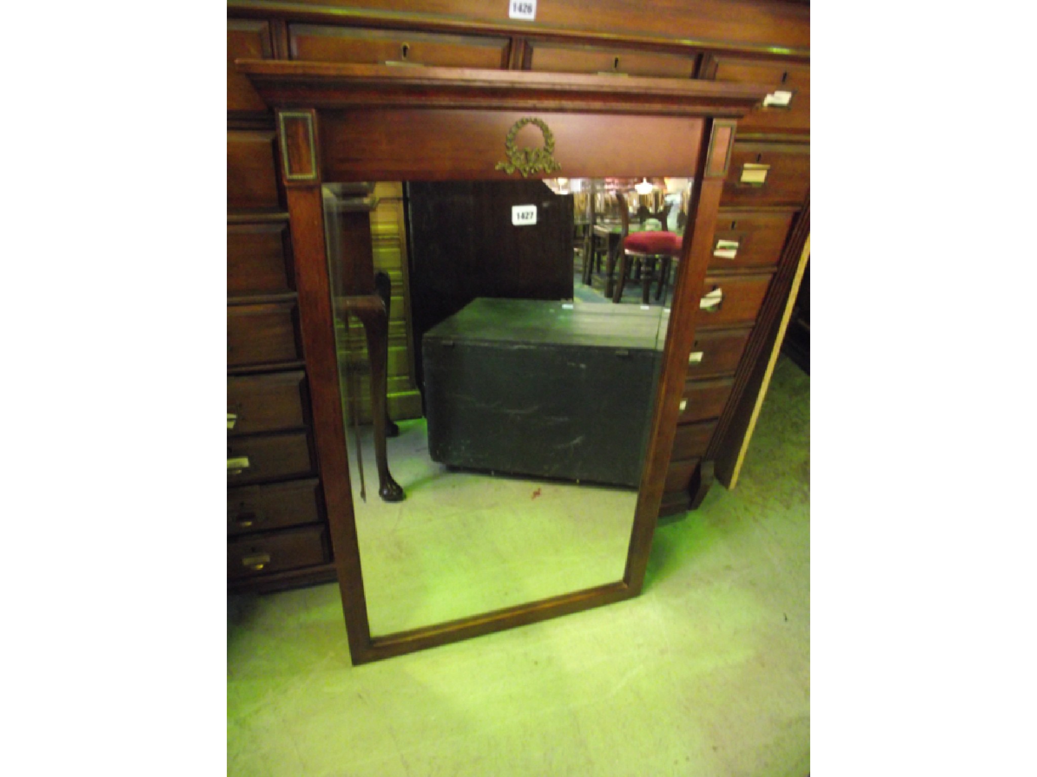 Appraisal: A mahogany wall mirror in the empire style with rectangular