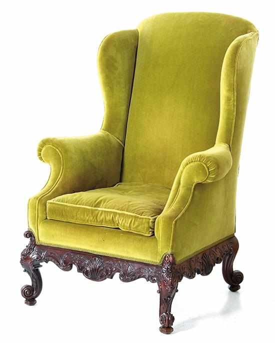 Appraisal: Chippendale style carved mahogany upholstered wingback armchair last half th