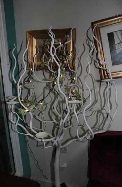 Appraisal: A CREAM PAINTED IRON 'TREE' with twisting branches and shallow