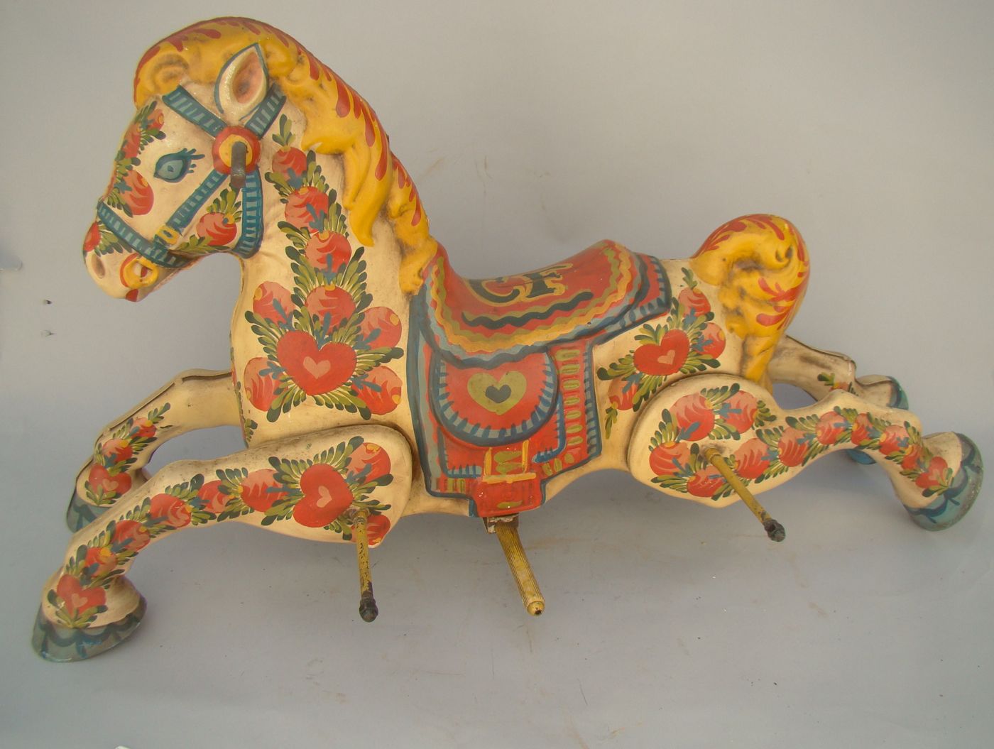 Appraisal: TIN CHILD'S ROCKING HORSE With heart and floral decoration Decorated