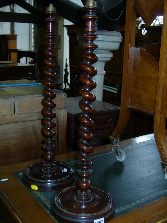 Appraisal: A pair of Edwardian walnut table lamps with tapering barley