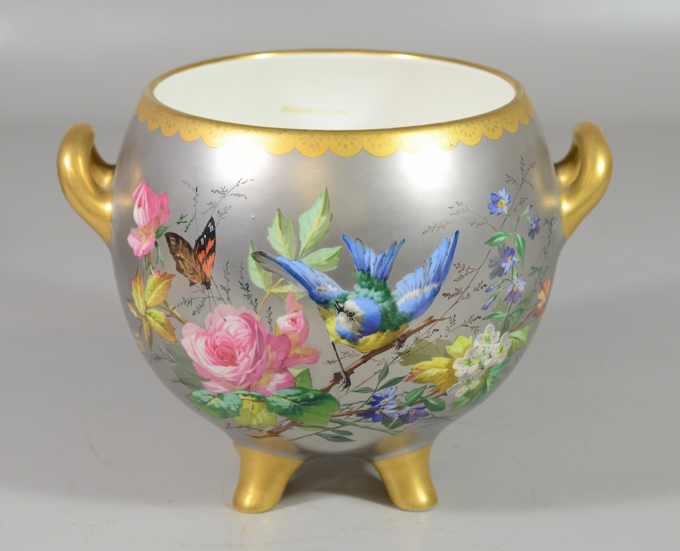 Appraisal: Platinum ground gilt hand painted floral butterfly bird decorated footed