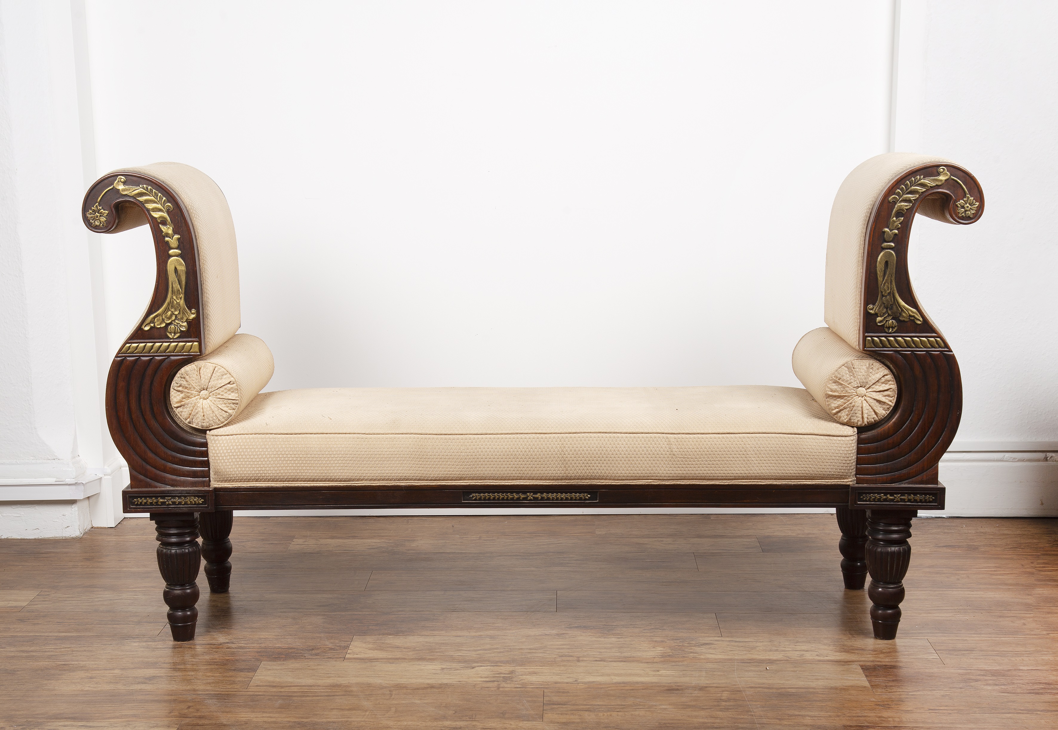 Appraisal: Empire style mahogany and parcel gilt large window seatwith scroll