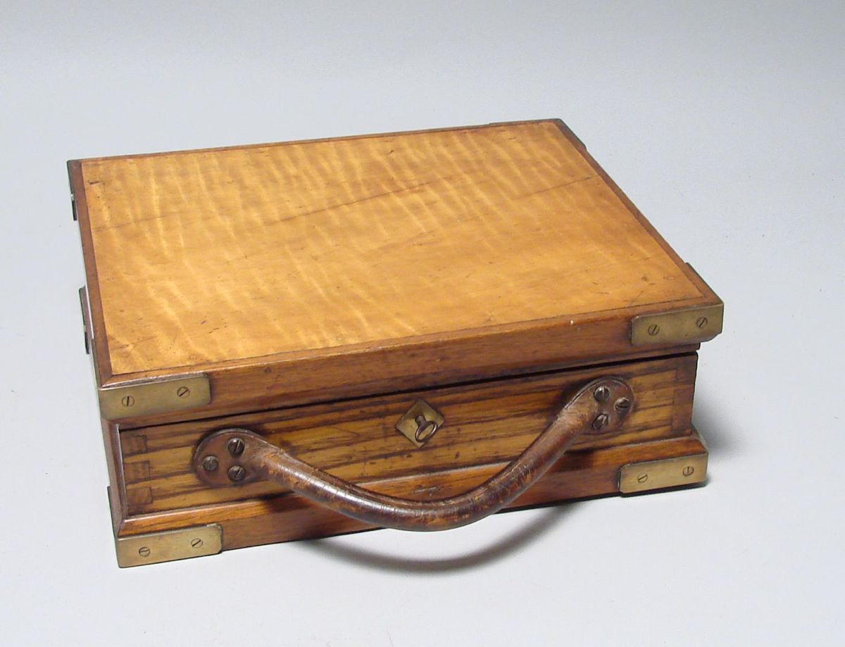 Appraisal: TIGER MAPLE LIFT-TOP BOX Late th CenturyWith brass corner mounts