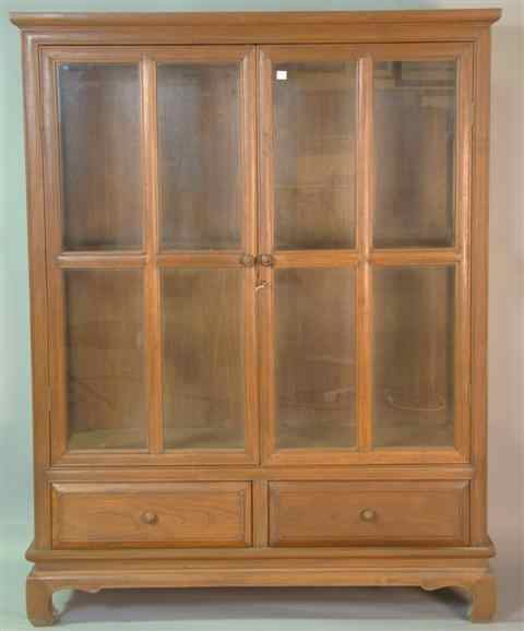 Appraisal: COLONIAL TEAK DISPLAY CABINET the molded cornice above glazed cabinet