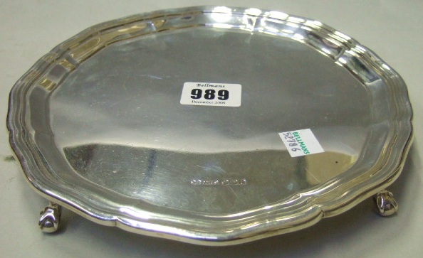 Appraisal: A silver shaped circular salver raised on four ball and