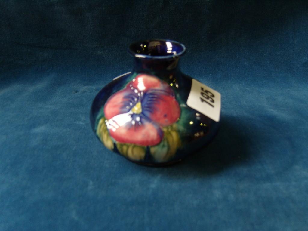 Appraisal: A small blue ground Moorcroft vase of squat circular form