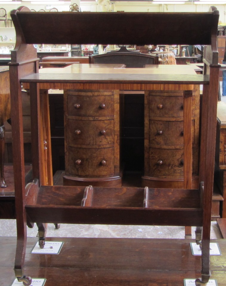 Appraisal: A Victorian oak two tier book trough on four splayed