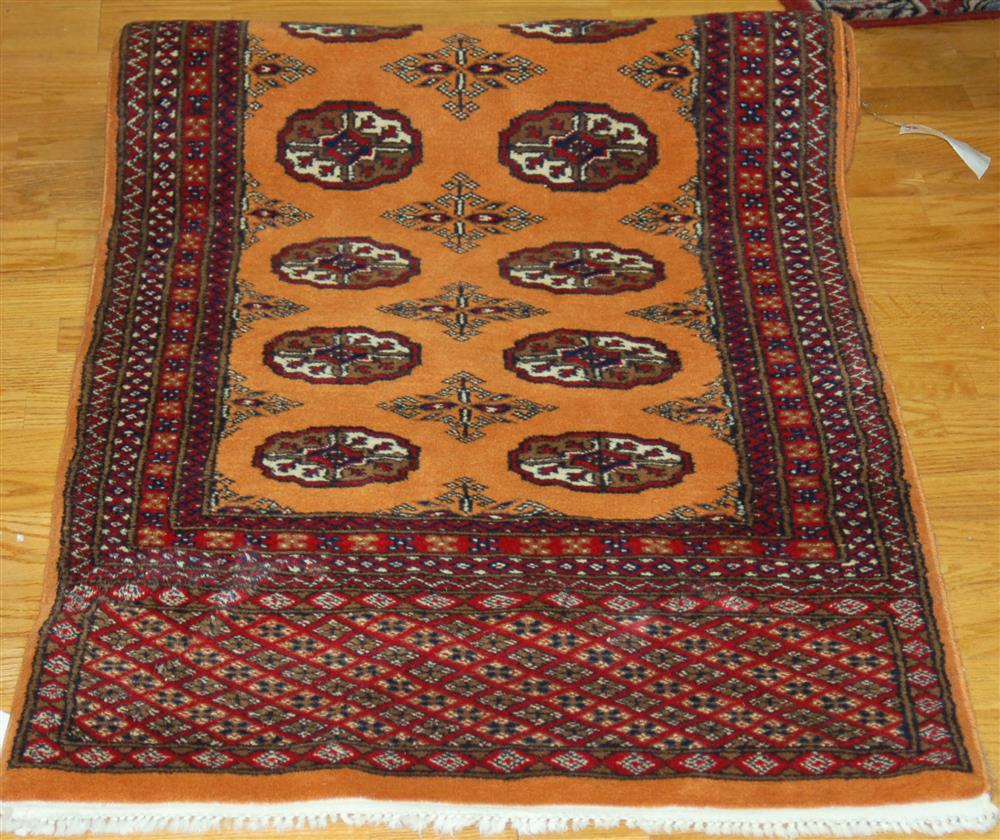 Appraisal: HANDMADE BOKHARA RUNNER having a gold center red border accents