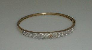 Appraisal: A diamond set hinged bangle with less than pts of