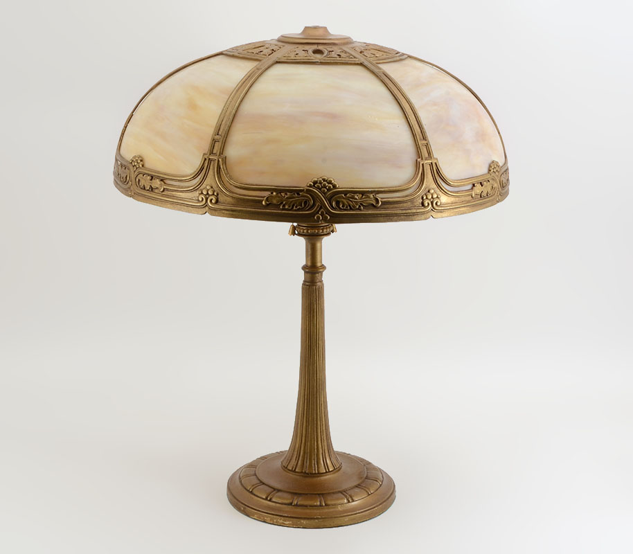 Appraisal: CARAMEL SLAG GLASS BENT PANEL LAMP Gold decorated cast metal