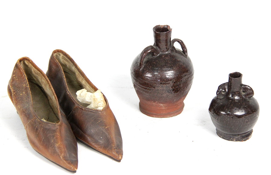 Appraisal: A pair of leather shoes and two pottery bottles