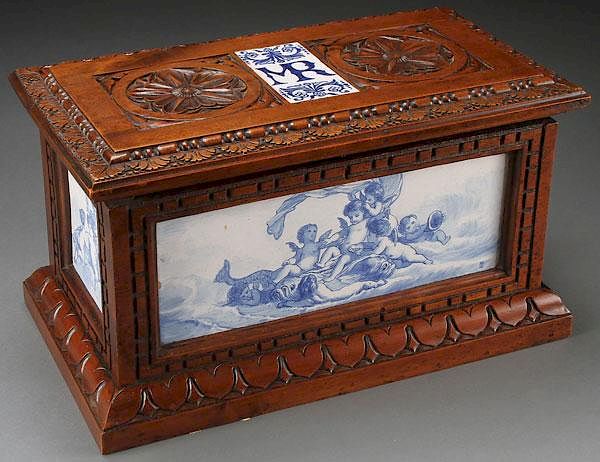 Appraisal: AN ITALIAN CARVED WALNUT AND MAJOLICA CASKET AN ITALIAN CARVED