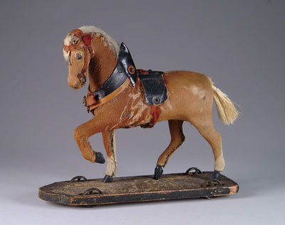 Appraisal: HIDE-COVERED HORSE ON PLATFORM A fine glass-eyed horse with tack