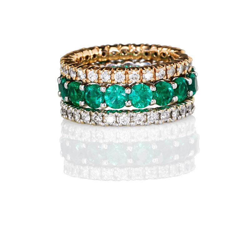 Appraisal: STACK OF EMERALD OR DIAMOND K ETERNITY BANDS Two diamond