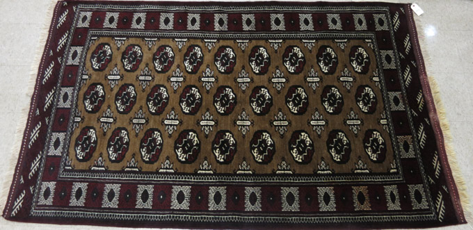 Appraisal: AFGHAN BOKHARA AREA RUG featuring a rectangular brown field of