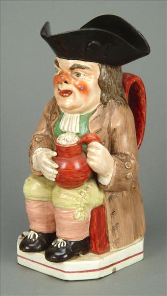 Appraisal: A Neale Co creamware toby jug typically modelled seated with