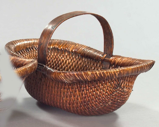 Appraisal: Provincial Woven Reed Basket with a central arched bentwood handle