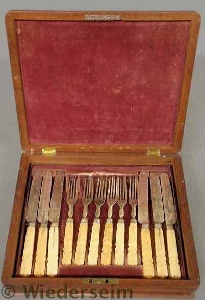 Appraisal: English mahogany cased knife and fork set with carved bone