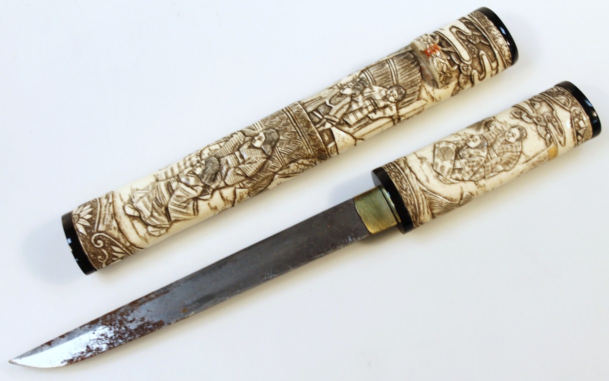 Appraisal: A thC carved bone Japanese Katana and scabbard heavily carved