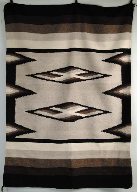 Appraisal: NAVAJO STYLE RUG Center section with tan background has two