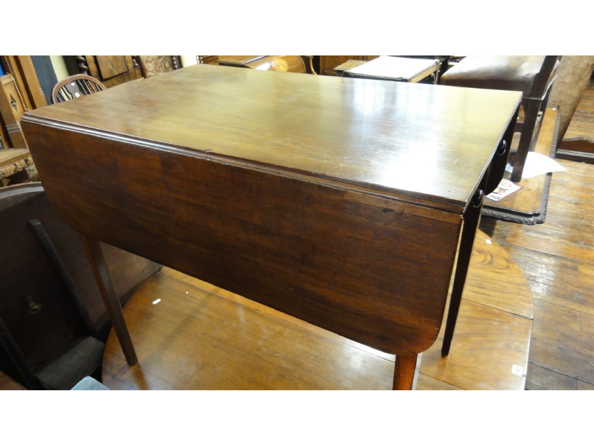 Appraisal: A Georgian mahogany Pembroke table fitted with a single frieze