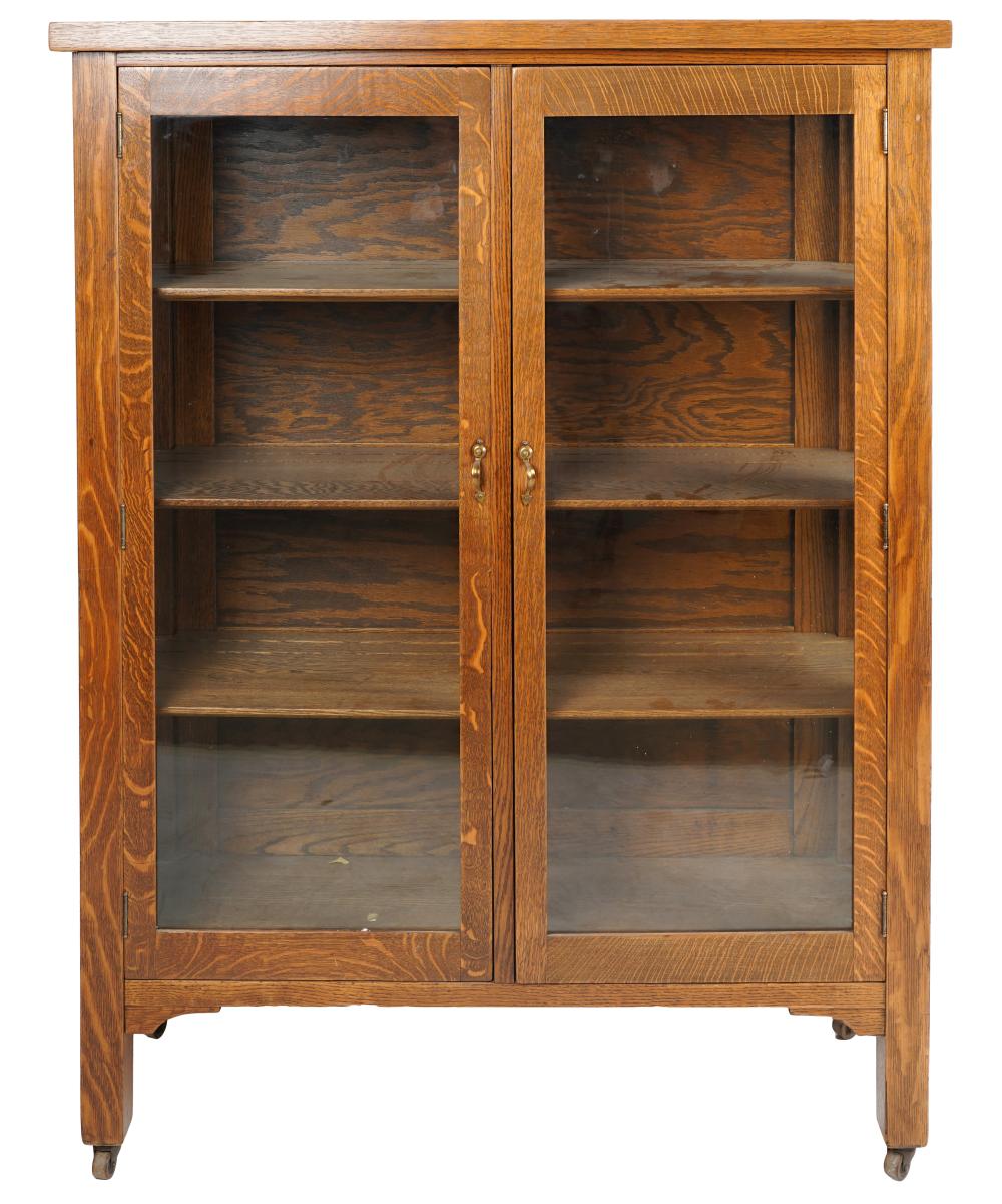 Appraisal: AMERICAN OAK BOOKCASEearly th century having three adjustable-height shelves enclosed