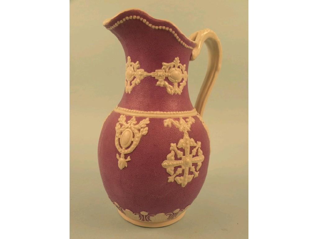 Appraisal: A thC relief moulded jug decorated in white with foliate