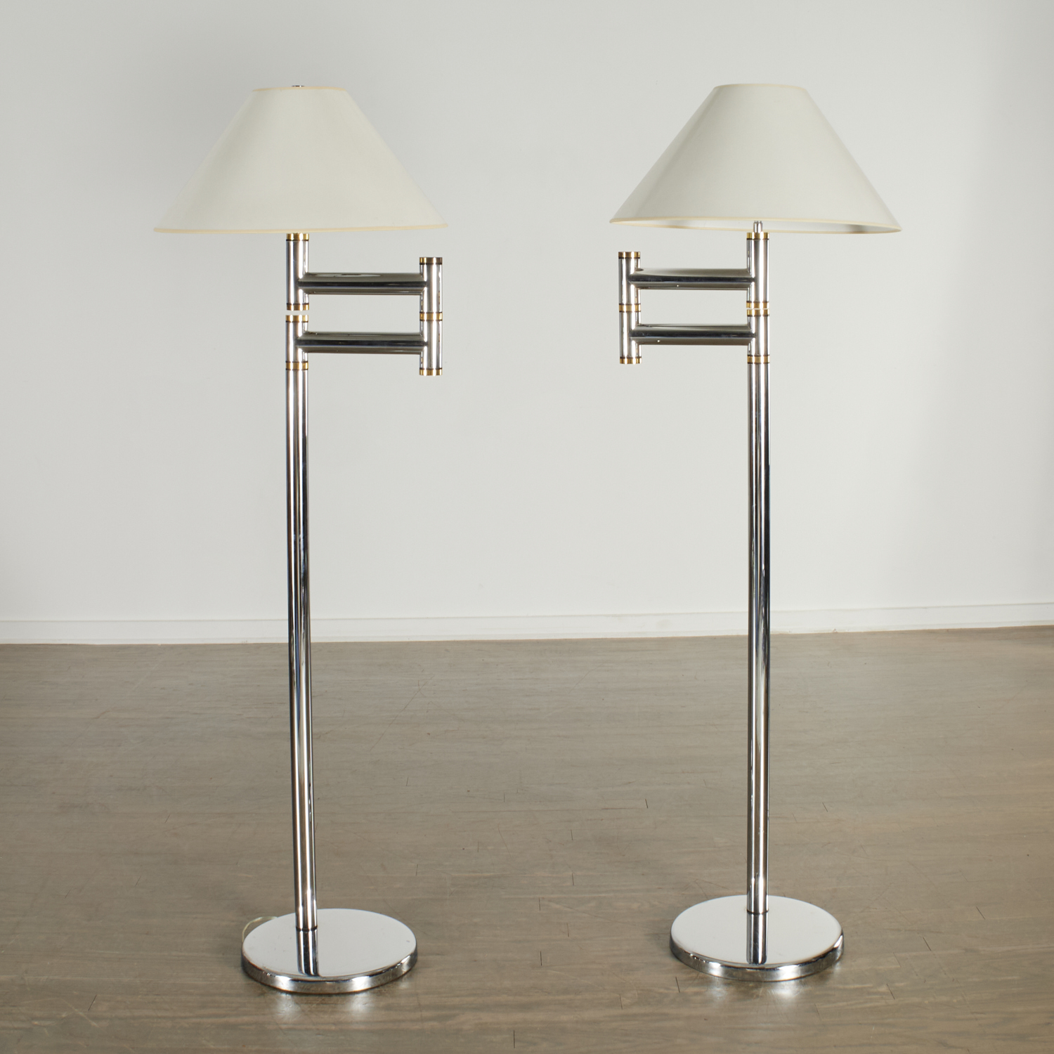 Appraisal: KARL SPRINGER PAIR SWING ARM FLOOR LAMPS c American chrome