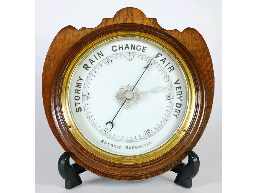 Appraisal: EARLY TWENTIETH CENTURY ANEROID BAROMETER mounted on an oak shield