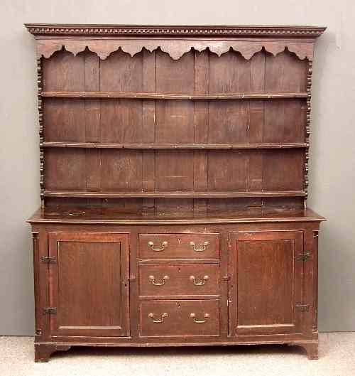 Appraisal: An th Century panelled oak dresser with a later rack