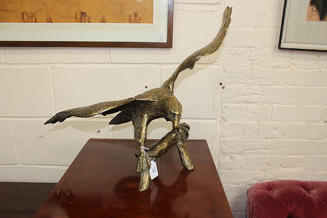 Appraisal: A SOLID BRASS STATUE OF AN EAGLE standing on a