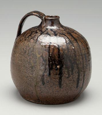 Appraisal: Stoneware jug apple shape with strap handle mottled brown glaze