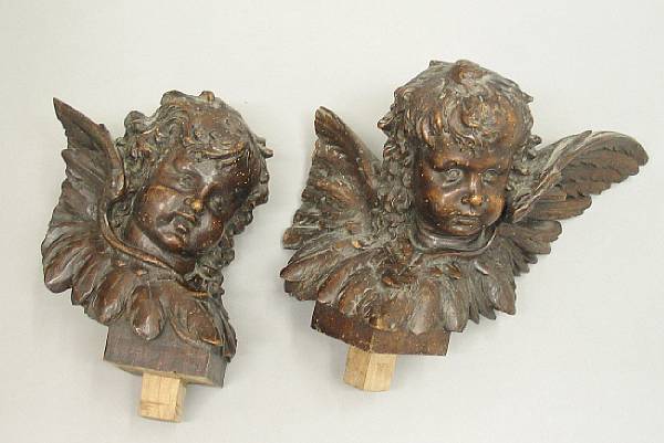 Appraisal: Two Italian carved walnut amorini th th century greatest height