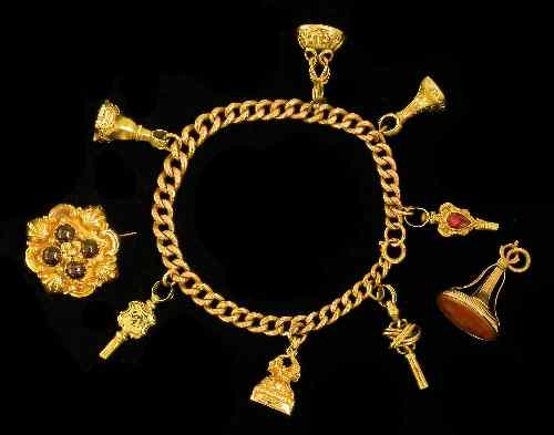 Appraisal: A ct gold link bracelet hung with seven pinchbeck mounted