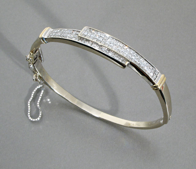 Appraisal: DIAMOND AND FOURTEEN KARAT WHITE AND YELLOW GOLD BANGLE pave'